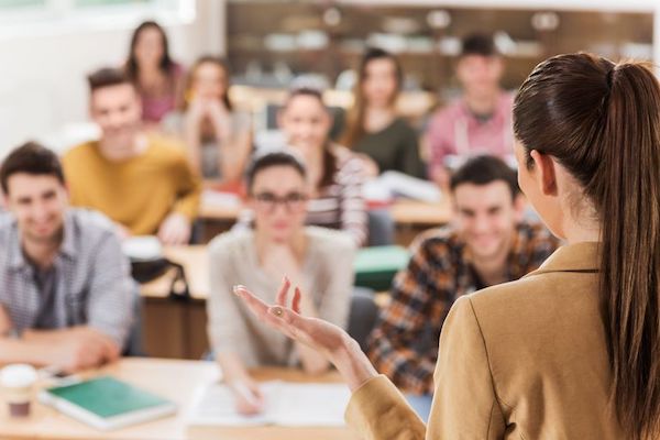 rear-view-of-teacher-giving-a-lecture